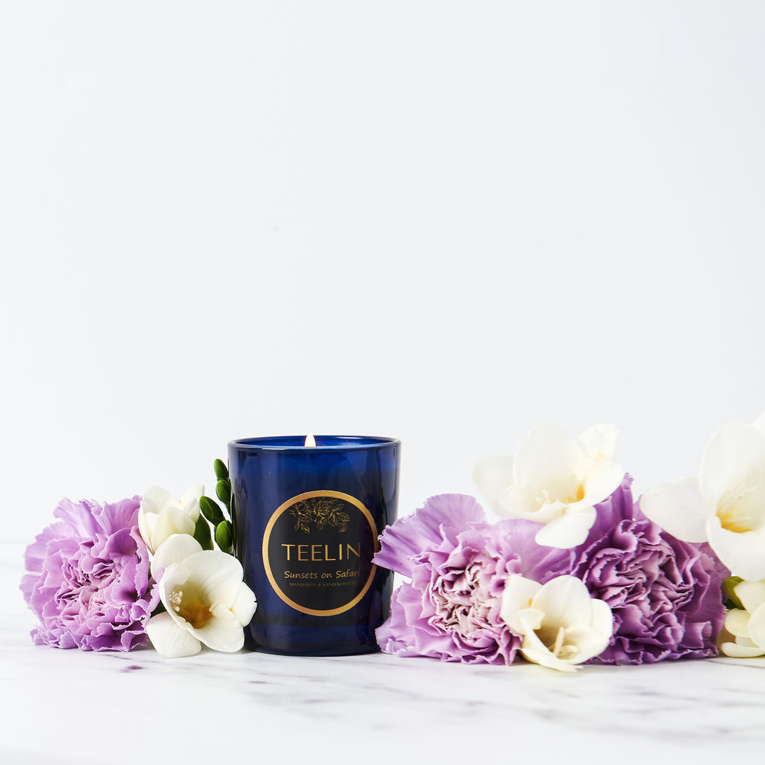 Blue Teelin bougie candle with flower decoration.