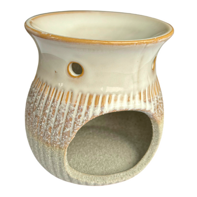 Ceramic wax burner with a sandstone base.