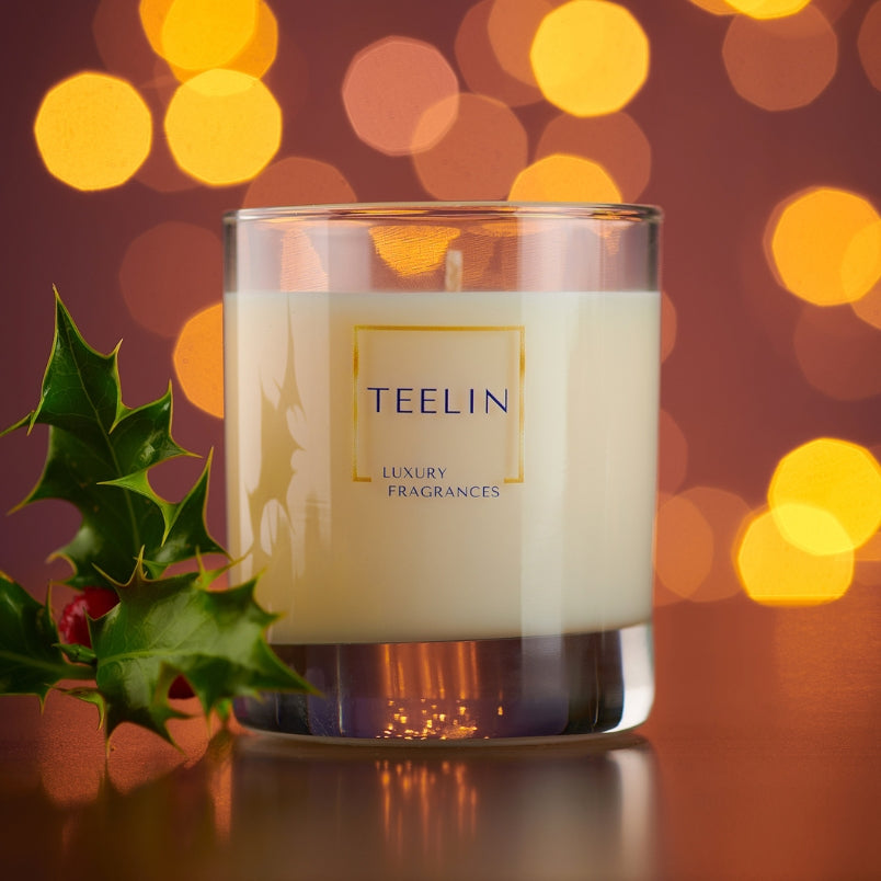 Teelin candle with holly leaf and red berries.